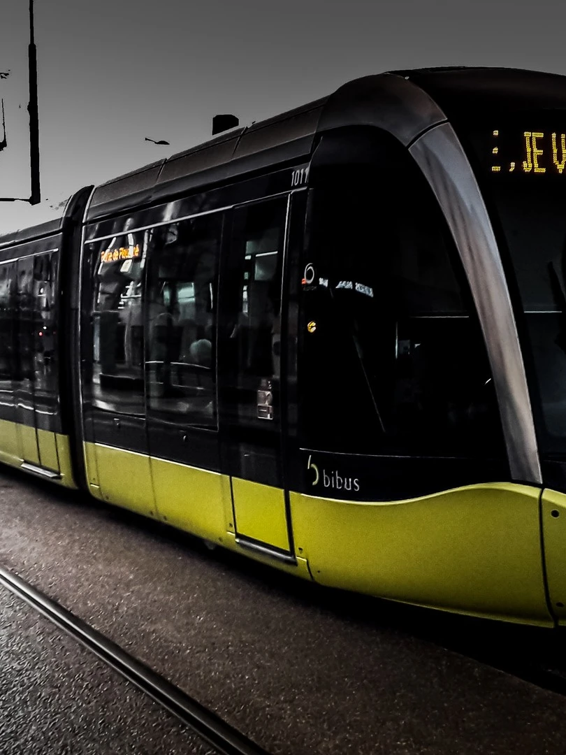 Photo 1 from Benjamin Simier’s Instagram post: Black and green tram of Brest in Bretagne, France, under a raining sky 🇫🇷🚡