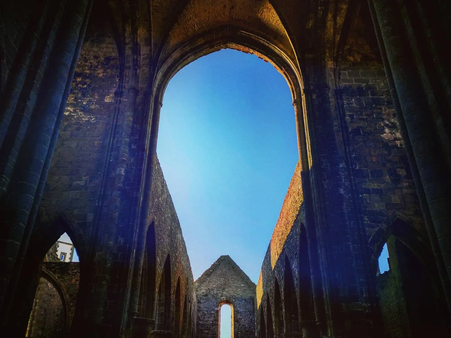 Photo 1 from Benjamin Simier’s Instagram post: Ruin of an old abbey in Bretagne, France under a blue sky