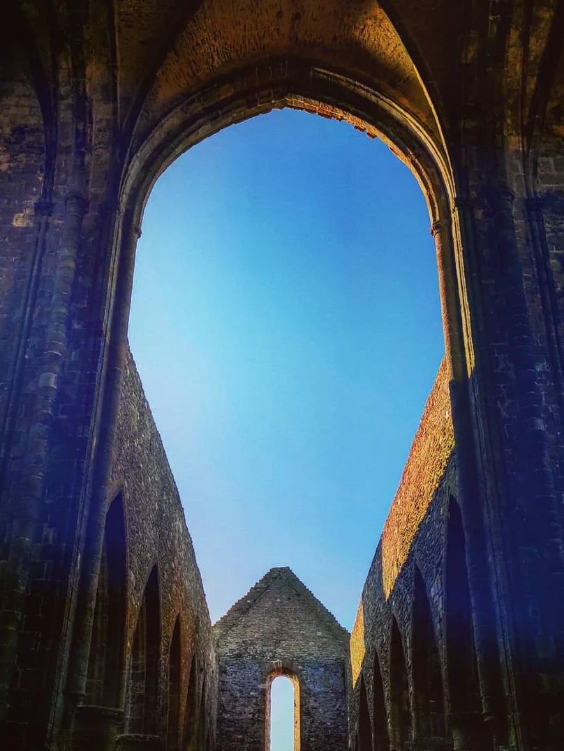 Photo 1 from Benjamin Simier’s Instagram post: Ruin of an old abbey in Bretagne, France under a blue sky