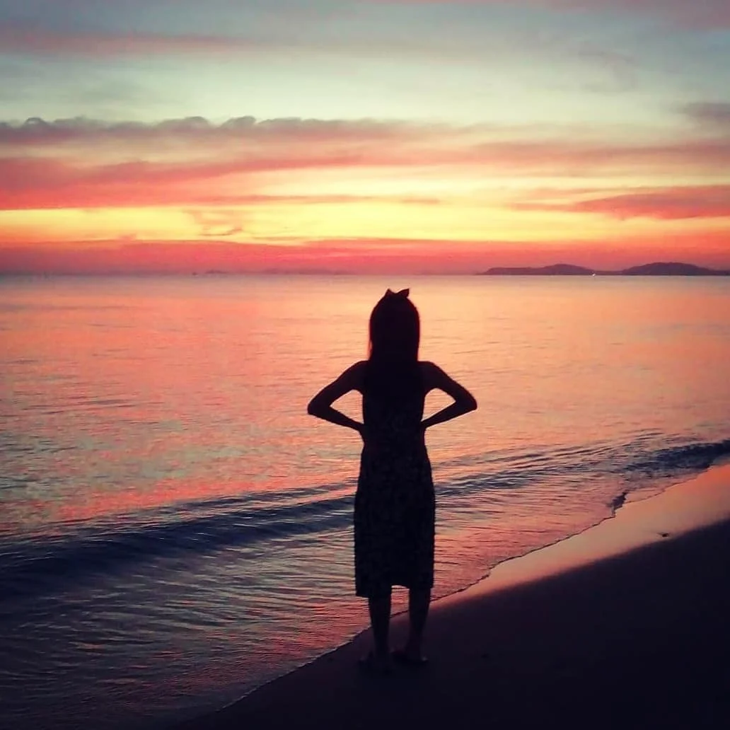 Photo 1 from Benjamin Simier’s Instagram post: My girlfriend watching a beautiful sunset on the beach ⛱️ in Rayong, Thailand 🌞