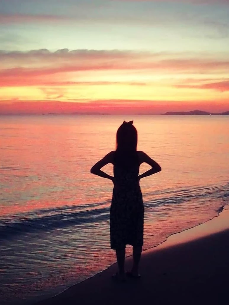 Photo 1 from Benjamin Simier’s Instagram post: My girlfriend watching a beautiful sunset on the beach ⛱️ in Rayong, Thailand 🌞