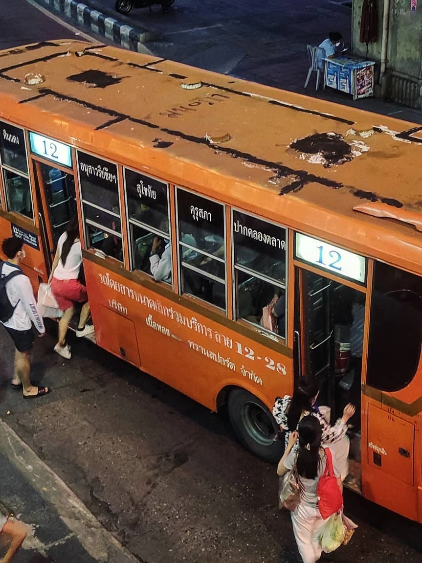 Photo 1 from Benjamin Simier’s Instagram post: Old orange bus in Bangkok, Thailand 🇹🇭