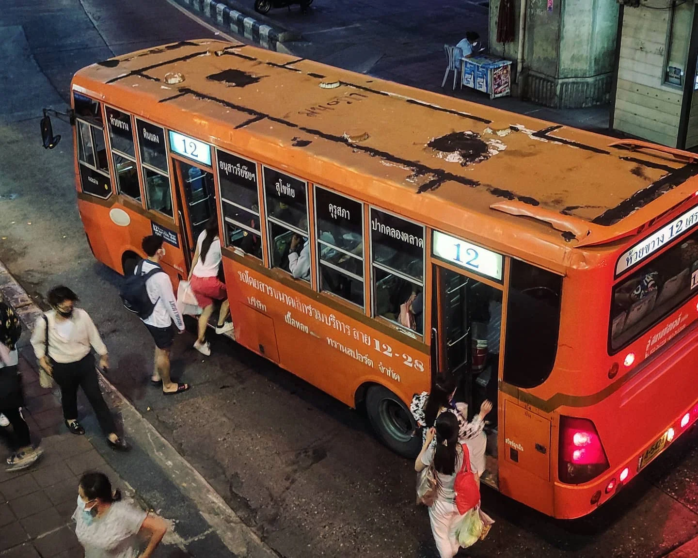 Photo 1 from Benjamin Simier’s Instagram post: Old orange bus in Bangkok, Thailand 🇹🇭