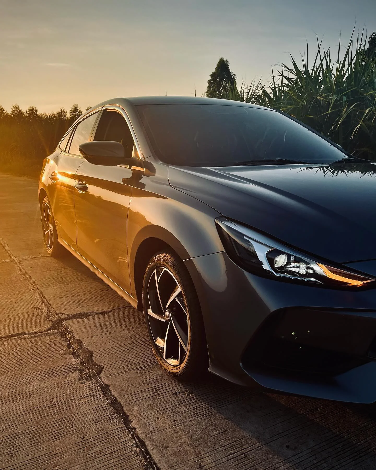 Photo 1 from Benjamin Simier’s Instagram post: A breathtaking sunset paints my stunning MG5 in golden hues - a perfect Buriram moment ✨