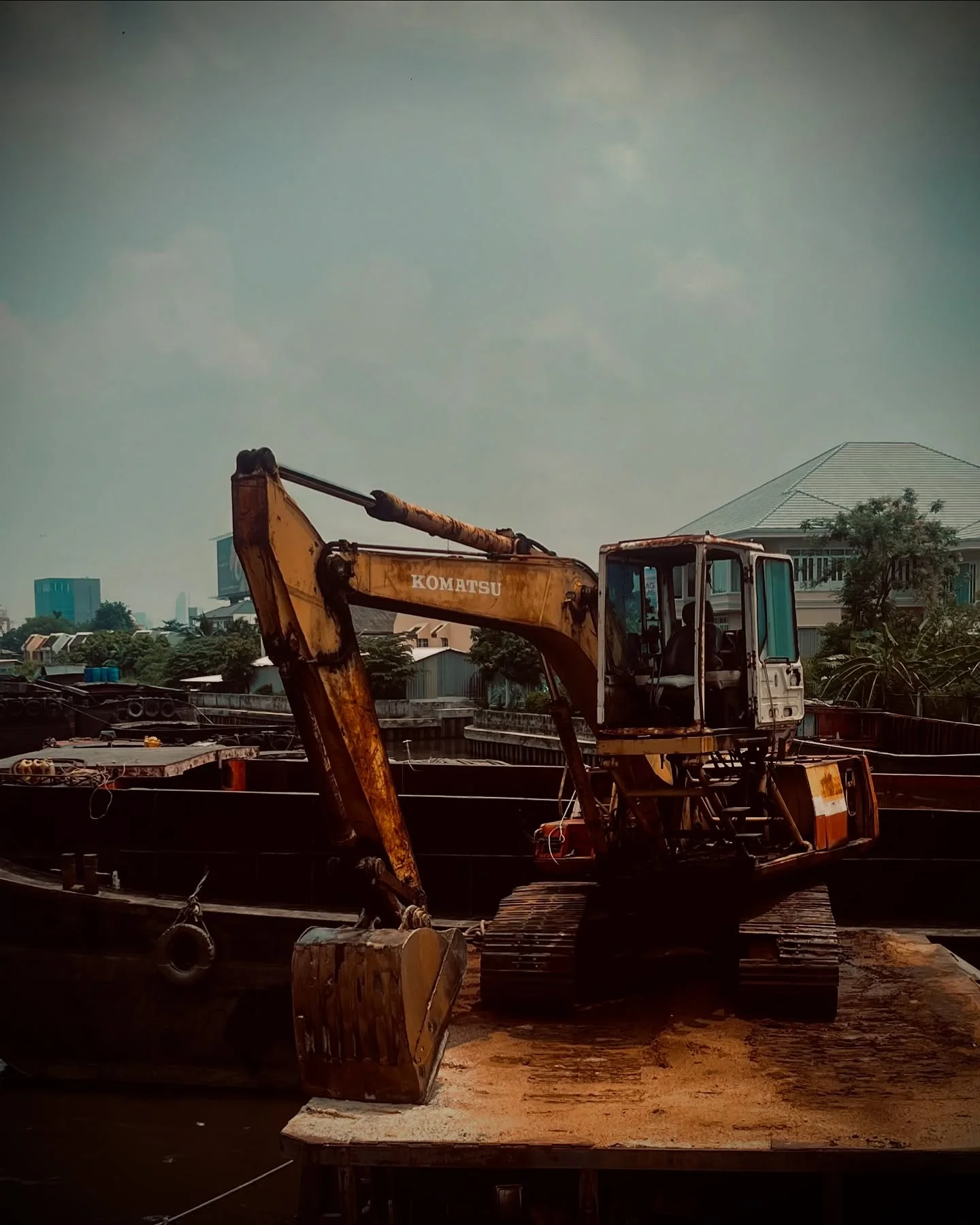 Photo 1 from Benjamin Simier’s Instagram post: grit and steel under a cloudy sky, machines resting between movements, city humming in the distance. 🛻 🏙️