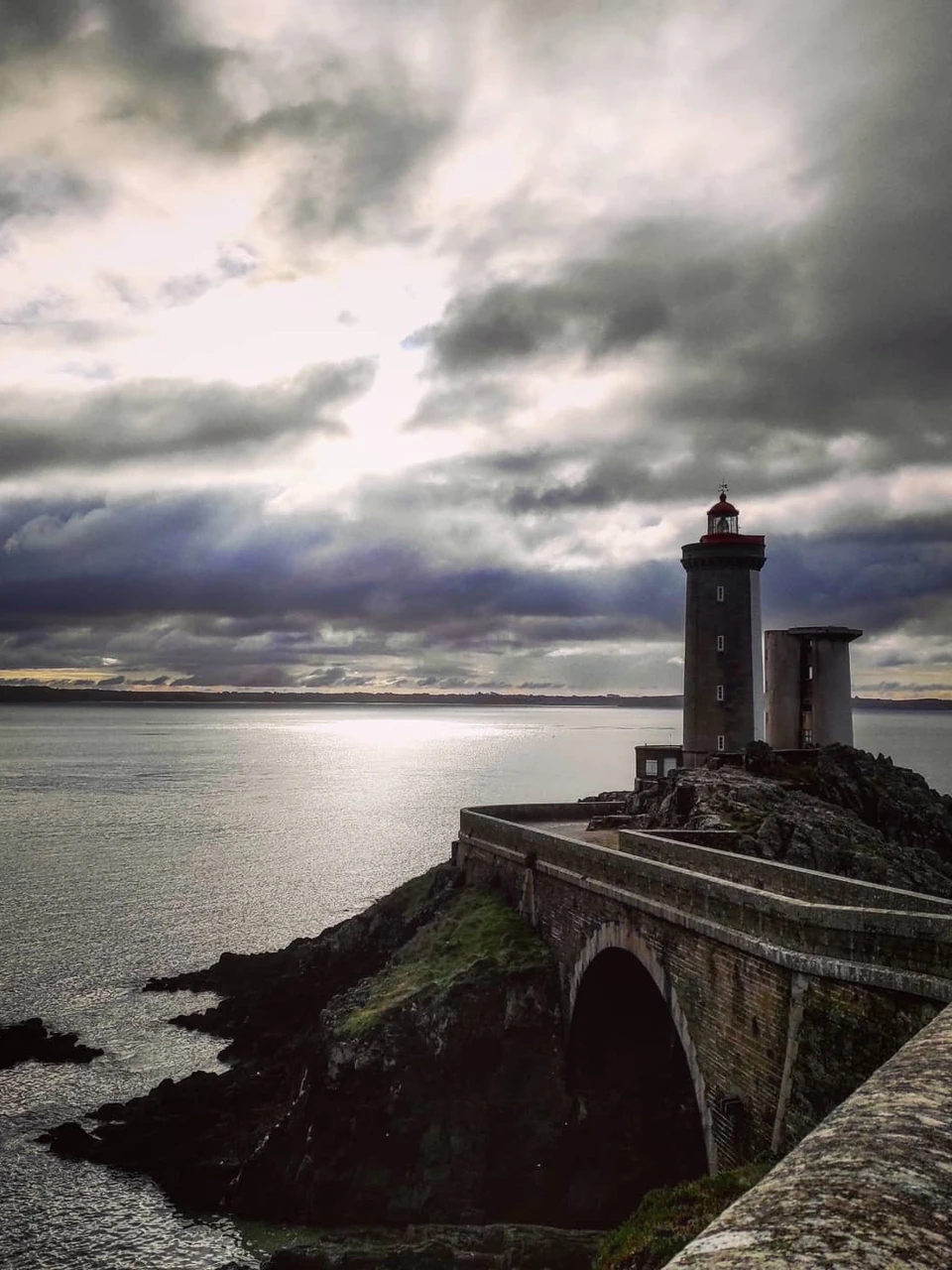Photo 1 from Benjamin Simier’s Instagram post: At the end of the land, facing the sea, under a cloudy and threatening sky, the Lighthouse of Petit Minou stands there, standing for more than a century.