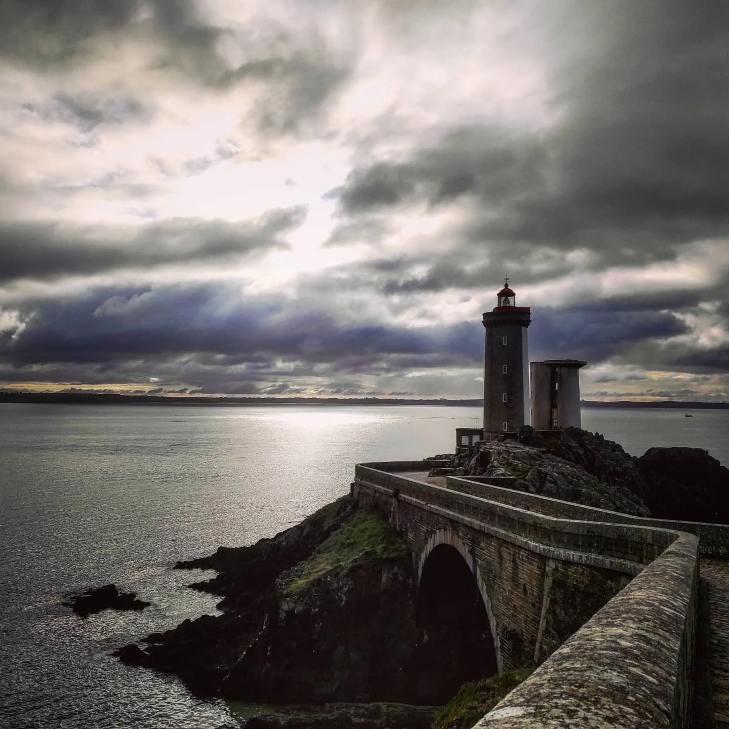 Photo 1 from Benjamin Simier’s Instagram post: At the end of the land, facing the sea, under a cloudy and threatening sky, the Lighthouse of Petit Minou stands there, standing for more than a century.